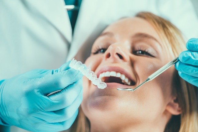 Lady getting her teeth whitened during procedure